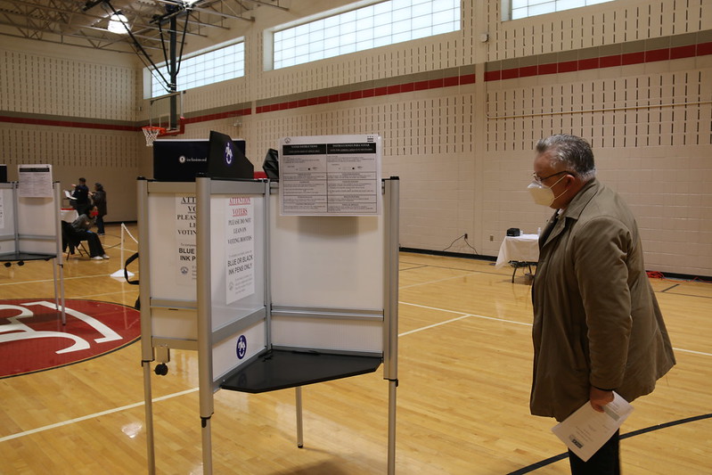 Michael Georg Link examines a voting booth in Washington, 3 Nov. 2020