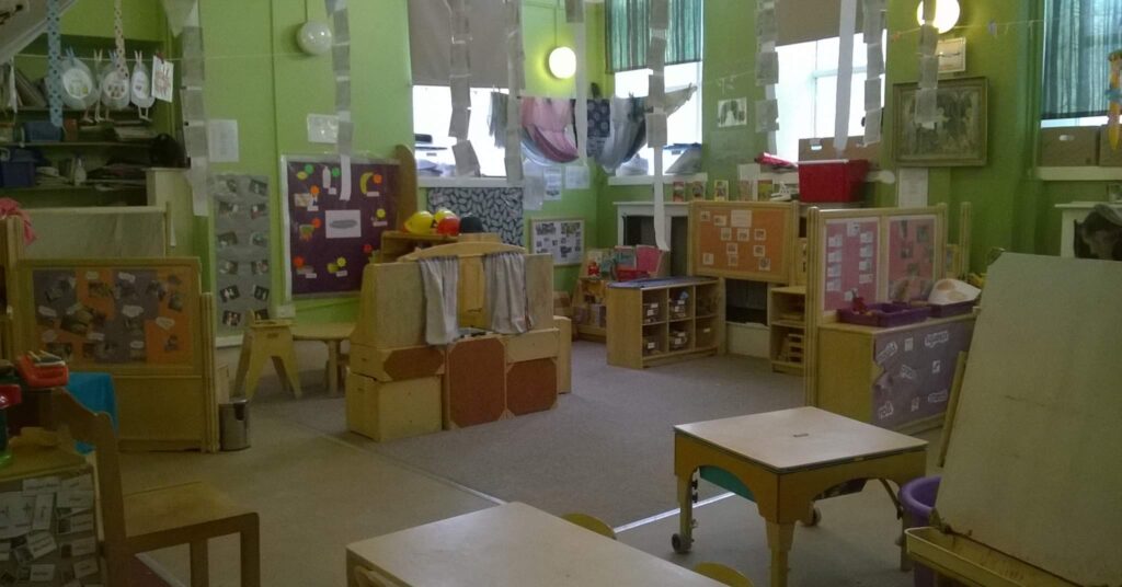 The interior of the nursery, with playsets on the floor and crafts lining the walls and ceiling.