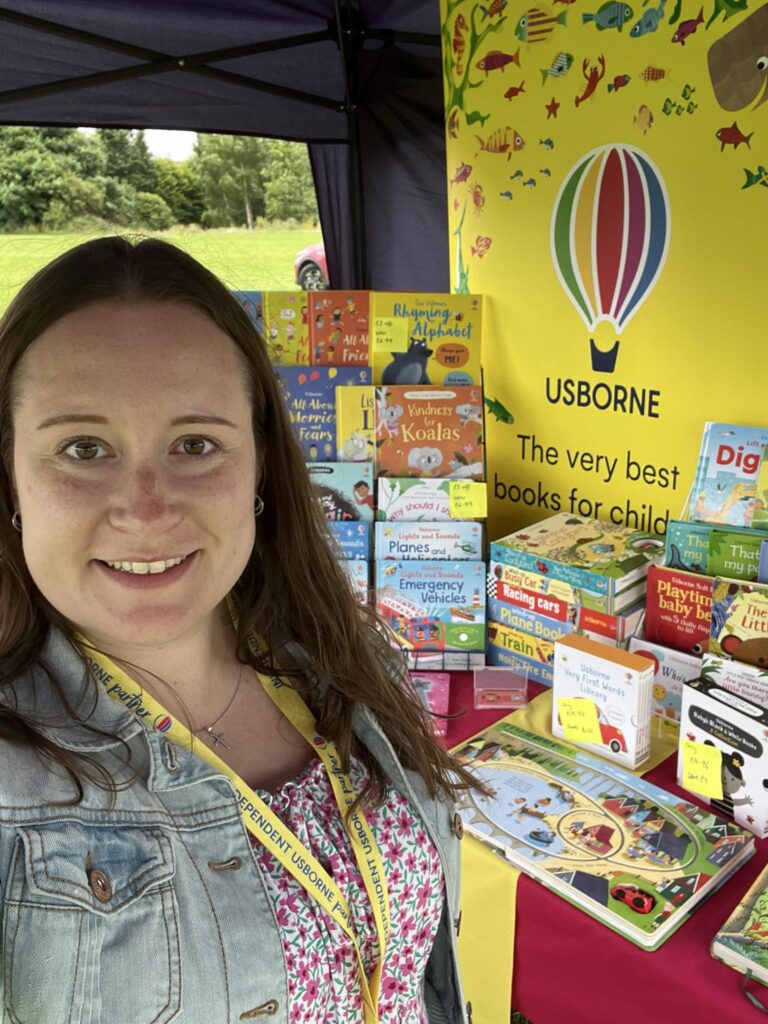 Charlotte Jenkins in front of an Usborne book display.