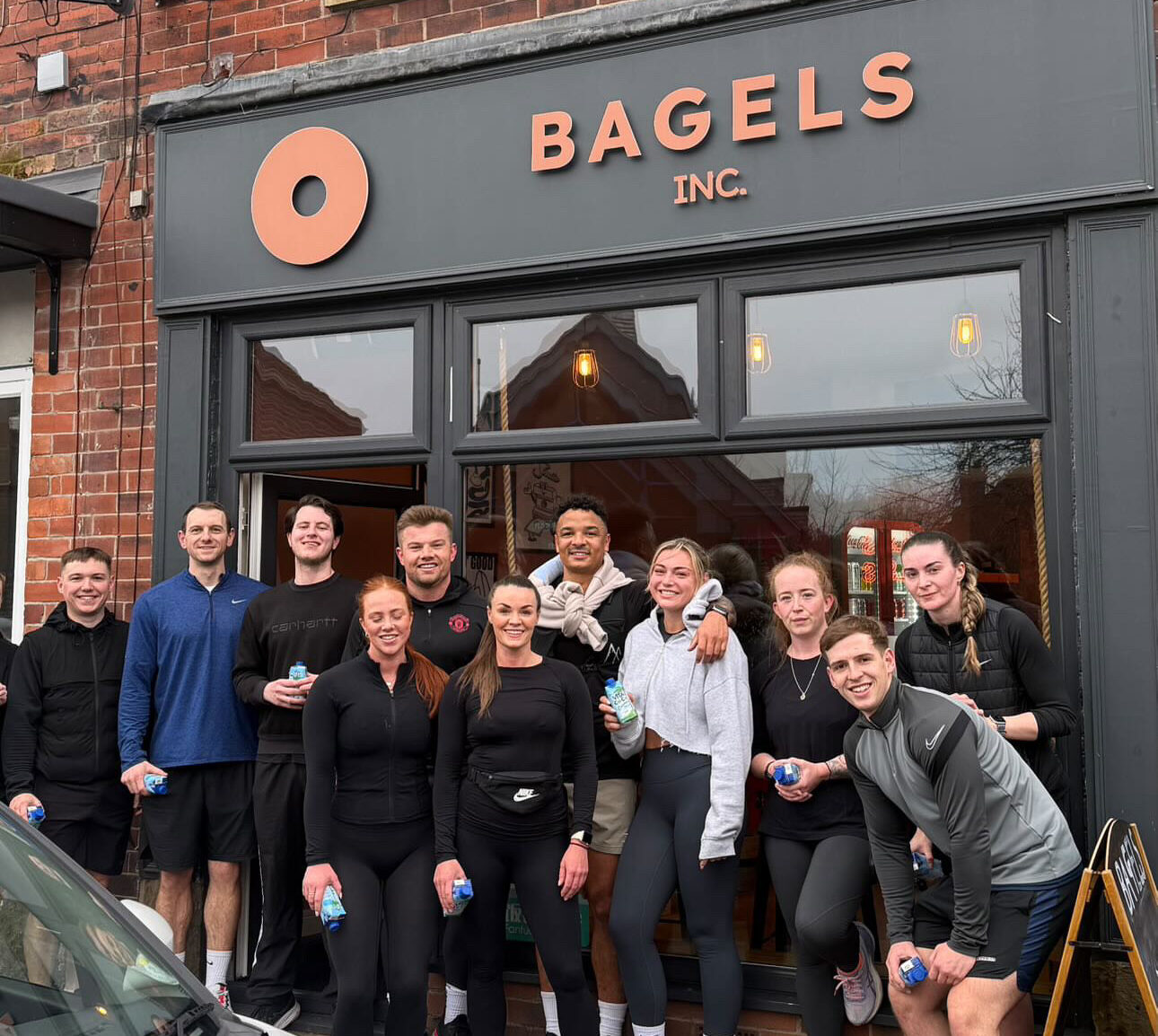 People who participated in the first run pose outside the store.