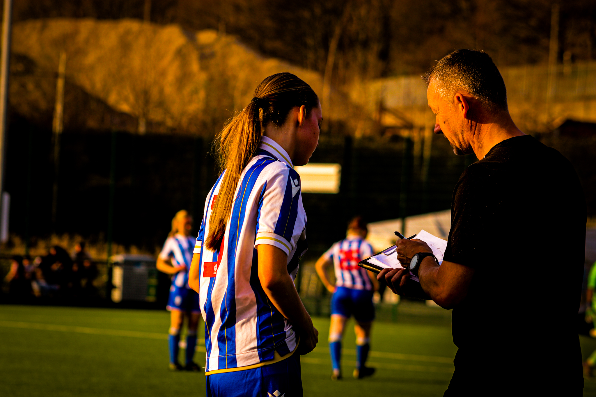 Sheffield Wednesday Ladies Head Coach giving a pep talk to a defender.