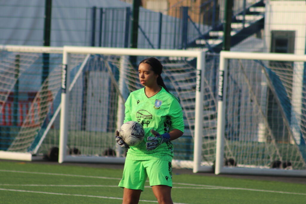 The Sheffield Wednesday Goalkeeper holds the ball.