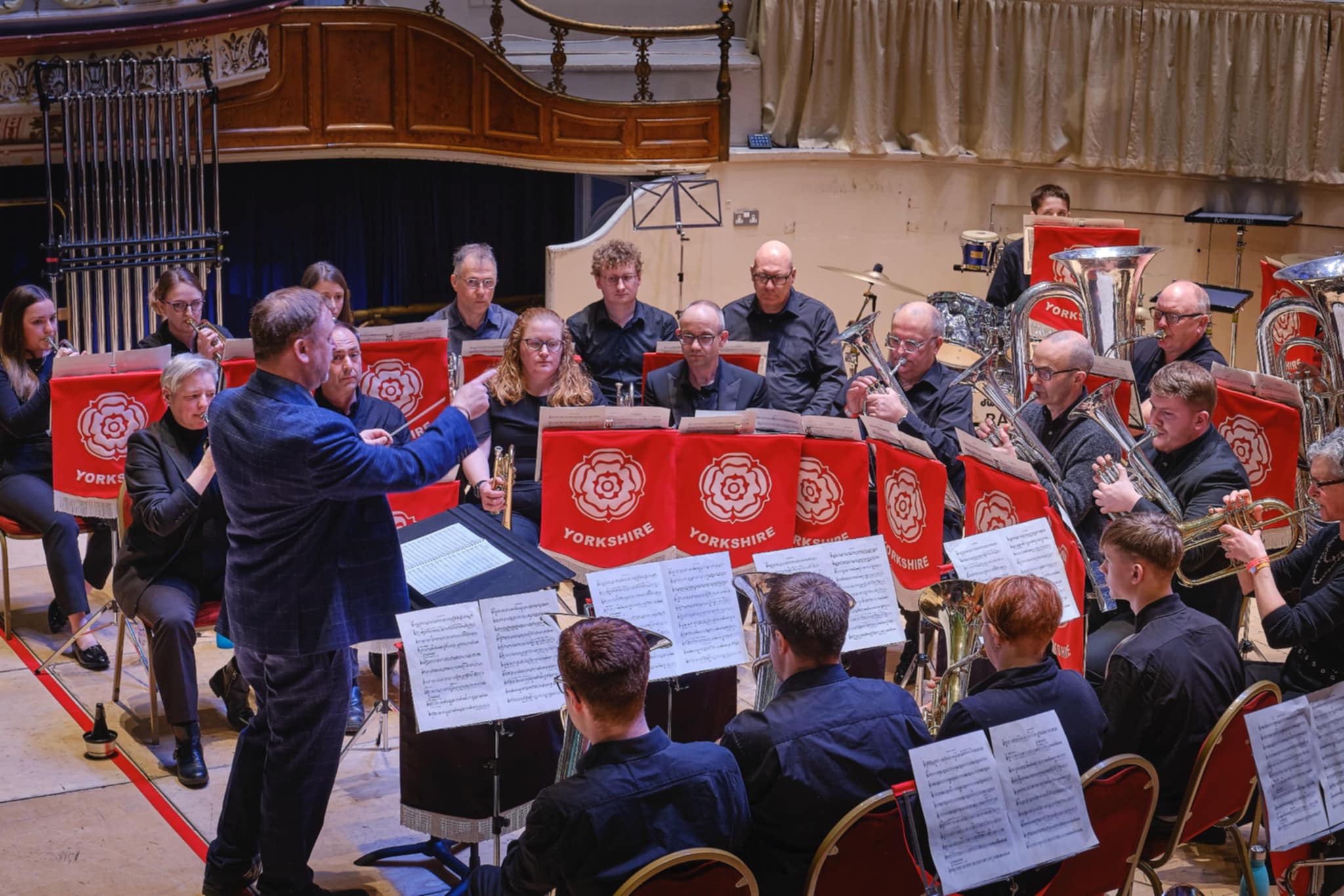 A photo of Crookes Brass Band performing at Huddersfield Town Hall at the Yorkshire Regional Championships.