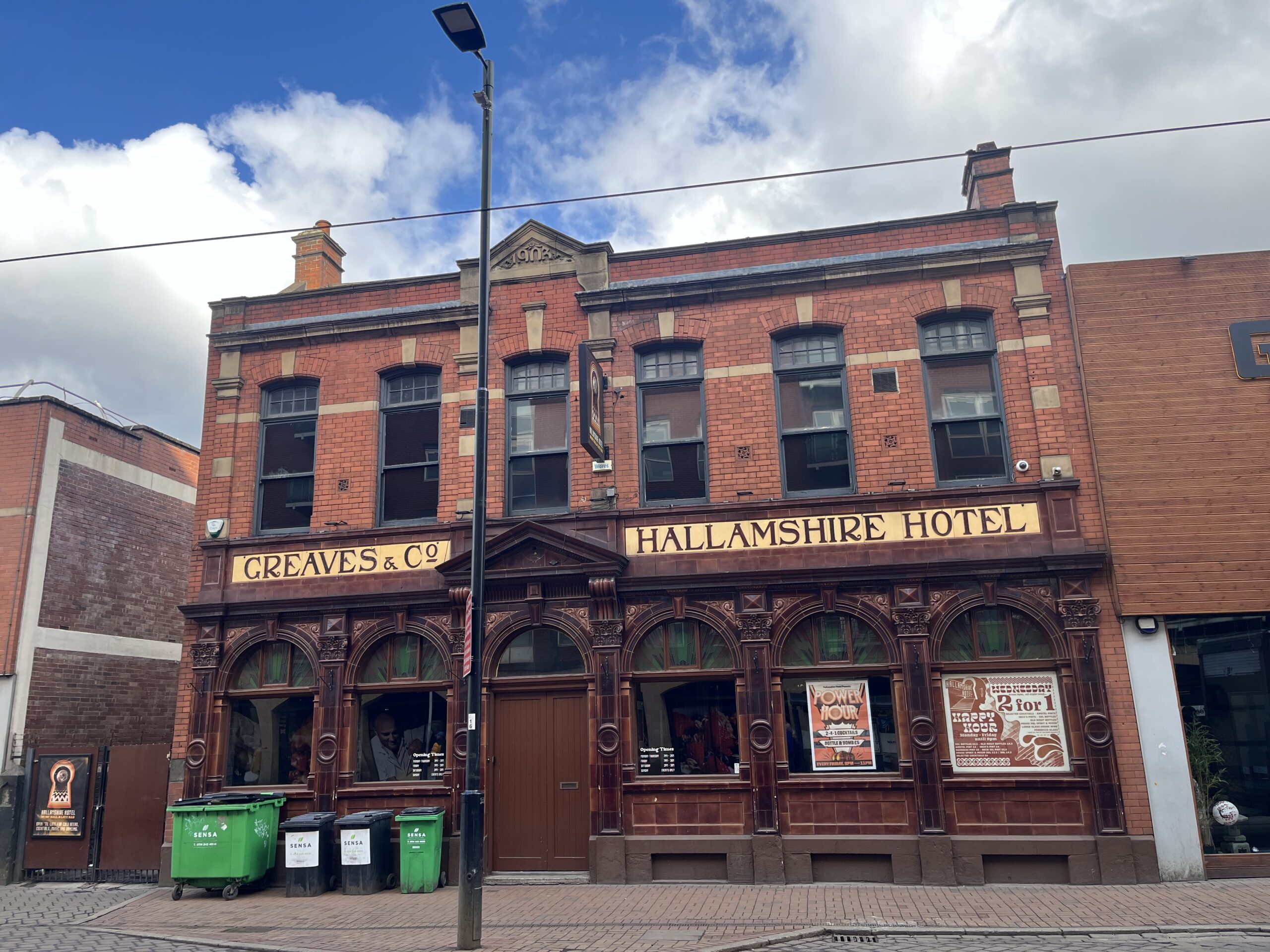 An outside picture of the Hallamshire Hotel on West Street in Sheffield which is a red brick two storey building