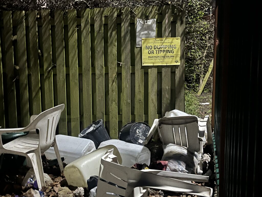 Image of rubbish under a sign that says No Dumping or Tippig