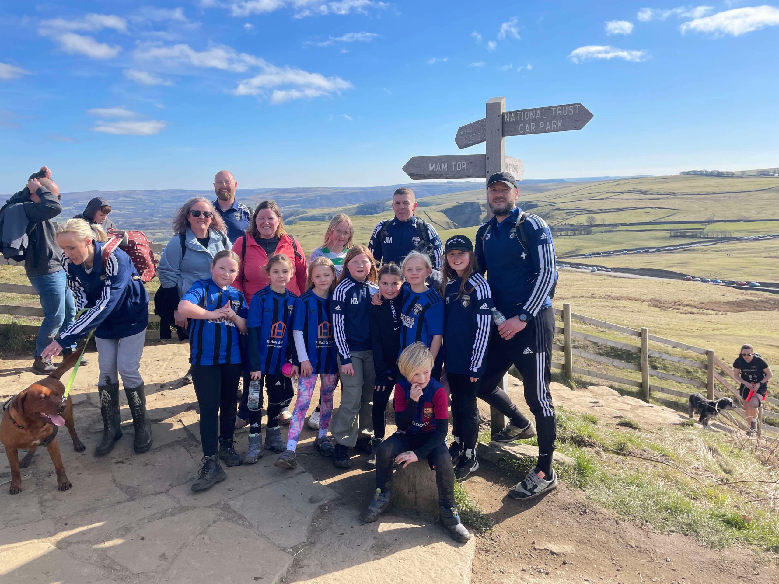 Picture shows the Lionesses and their families in a group photo at the top of Mam Tor hill