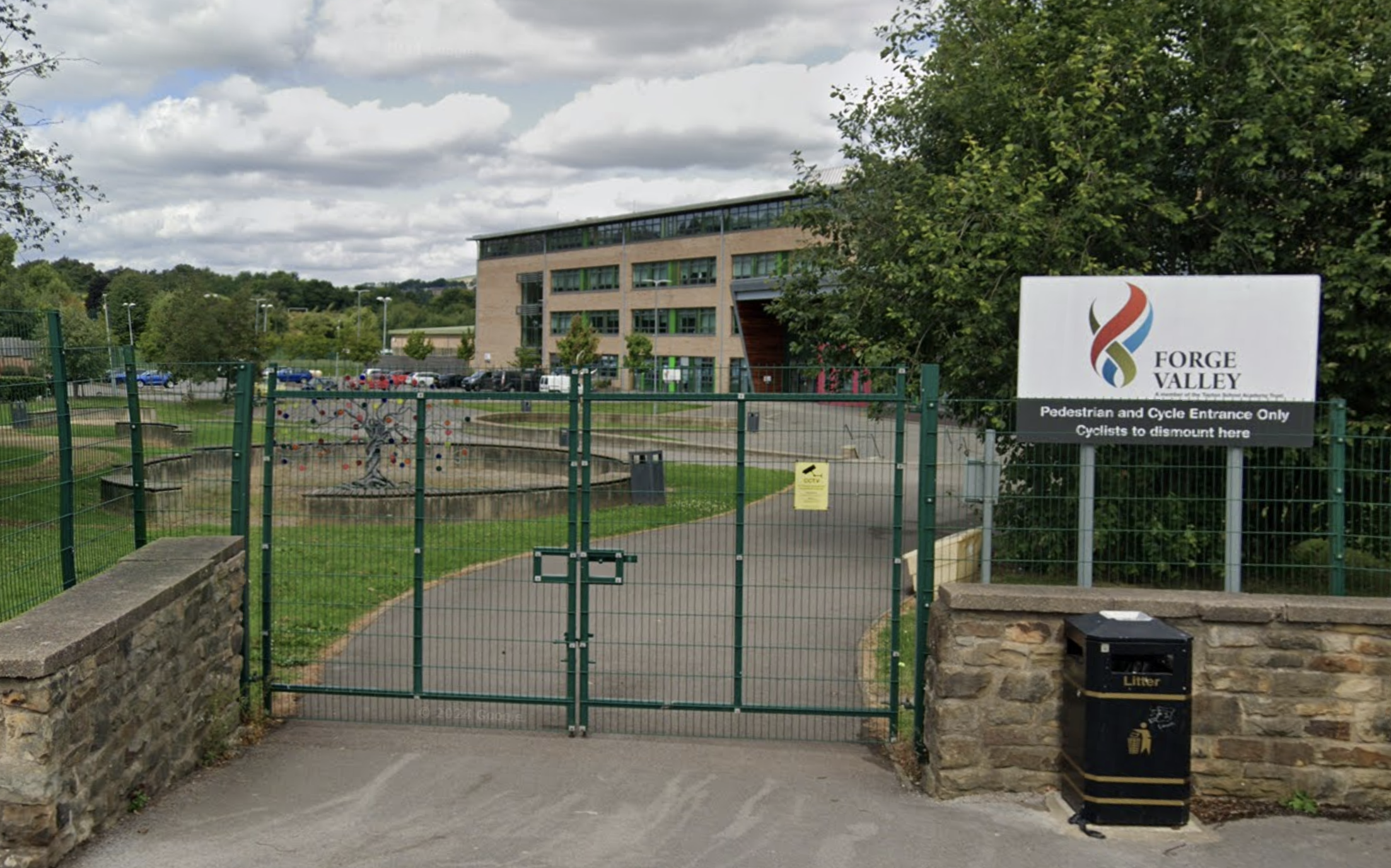 An image from the front gates of Forge Valley Secondary School in Stannington, with a view of the school building and the car park.