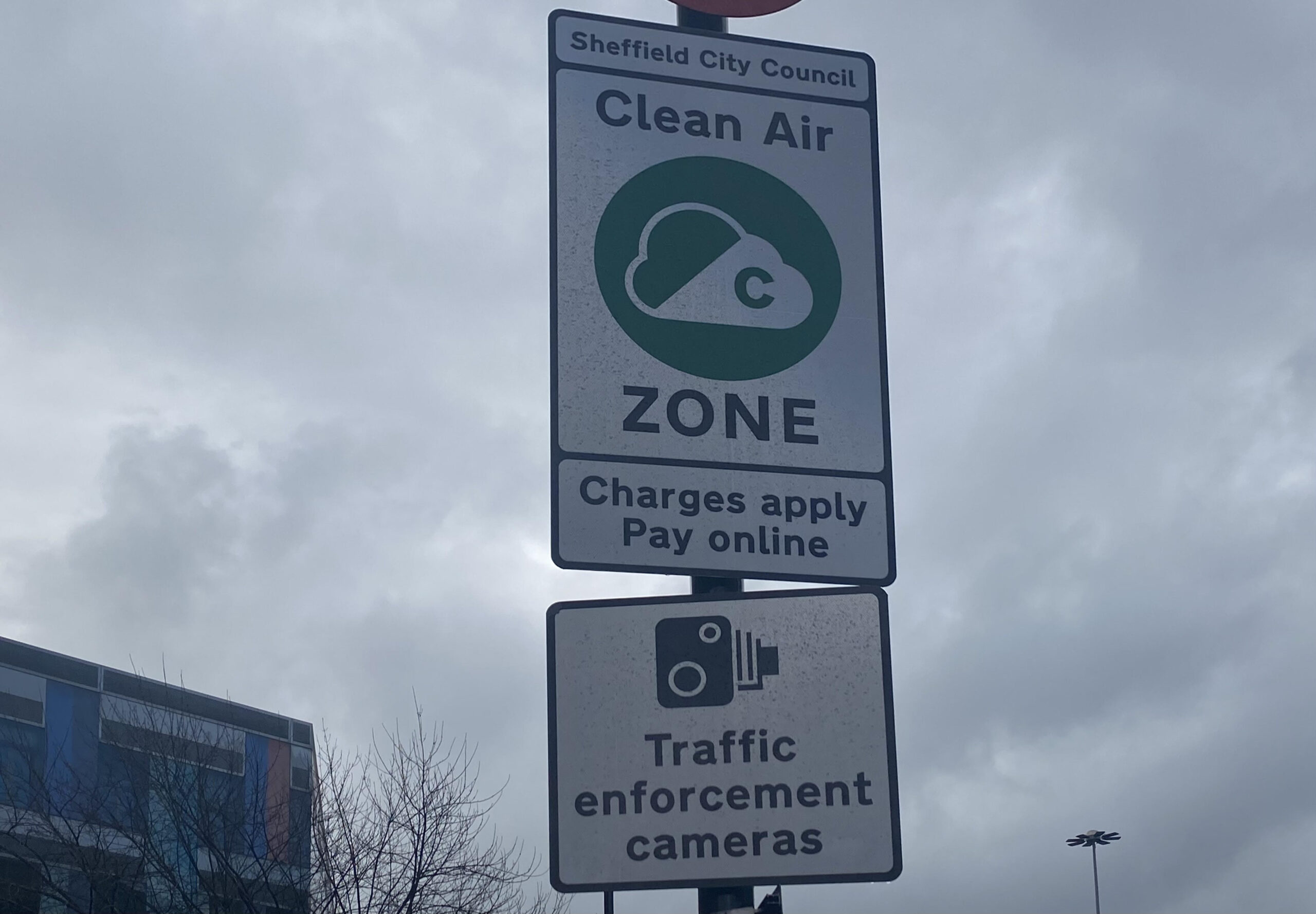 photo of a sign which says "clean air zone, charges apply, pay online"