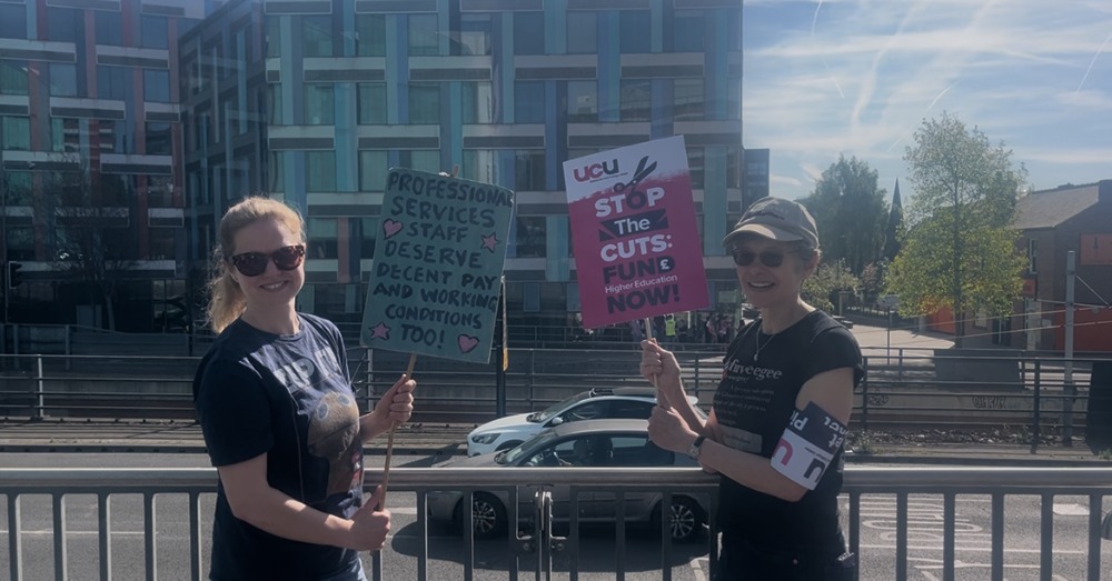Two strikers striking outside the university library