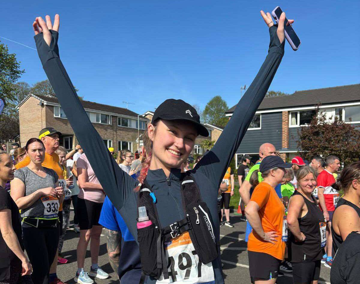 Woman with her hands up ready to run a marathon