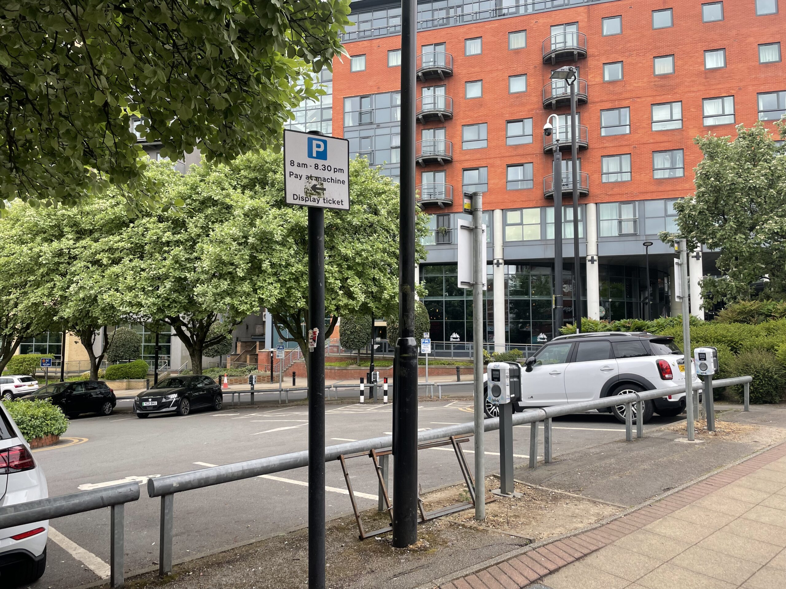 Image of car park with electric car charging spaces.