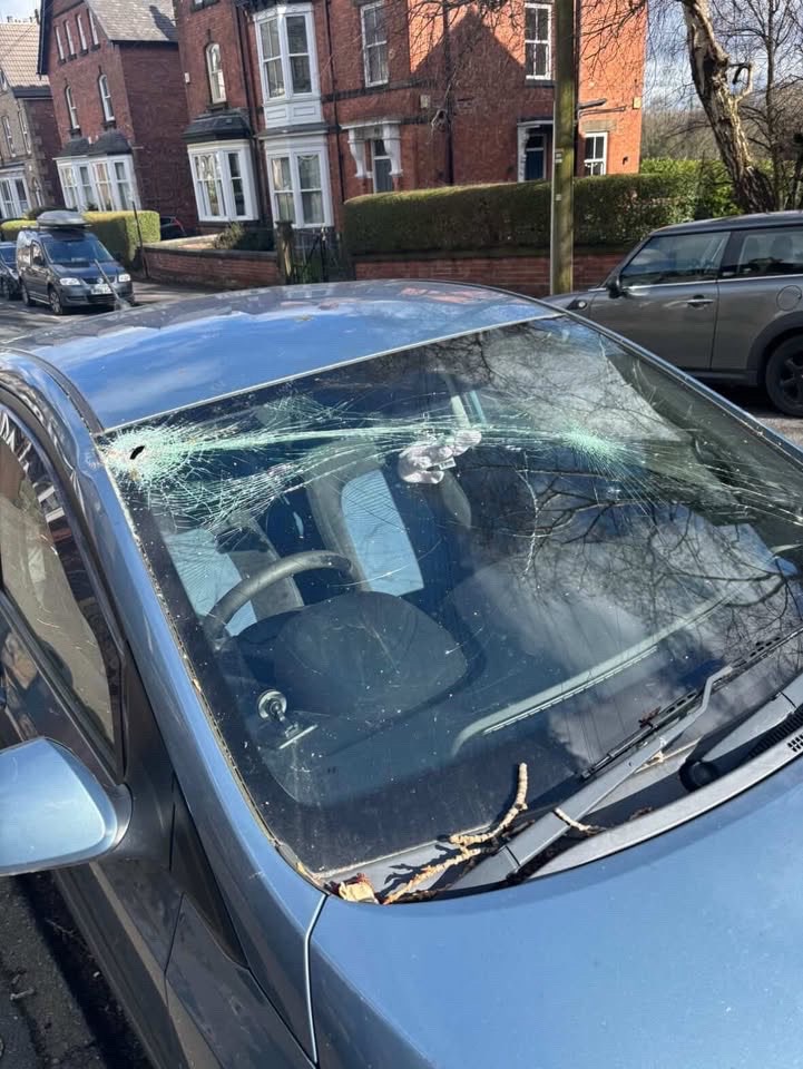 A photo showing the damage to the windscreen. A hole in the top left corner and a crack that extends to the bottom right.